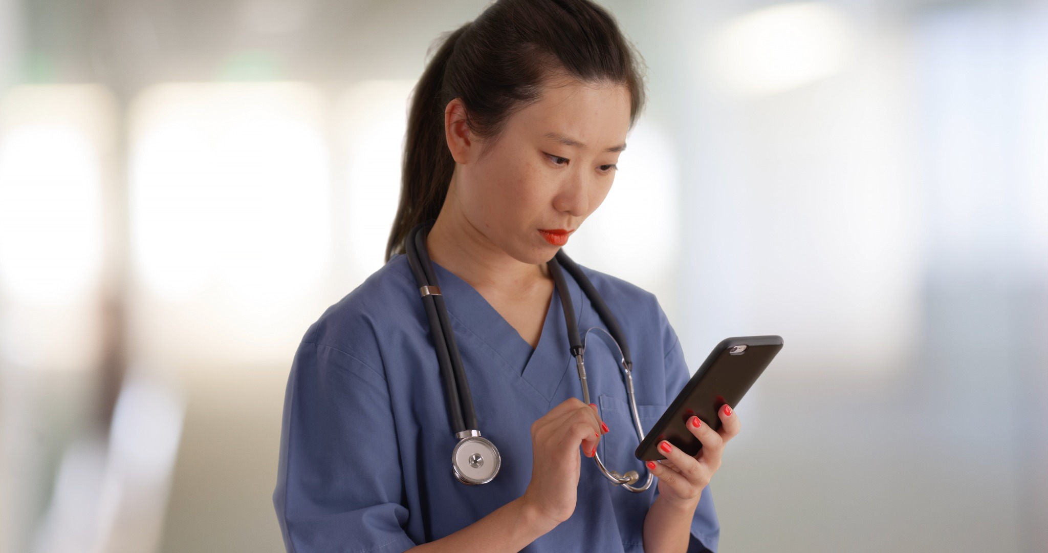 Doctor checking phone